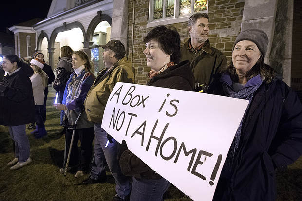 Patty Johnson, far right, her husband, Neal, and daughter, Rebecca, bring awareness to the issue of homelessness during the 2015 Lewiston-Auburn Homeless Memorial Vigil in Lewiston. PHOTO CREDIT: SUN JOURNAL, 2015.