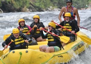 Group of people white water rafting